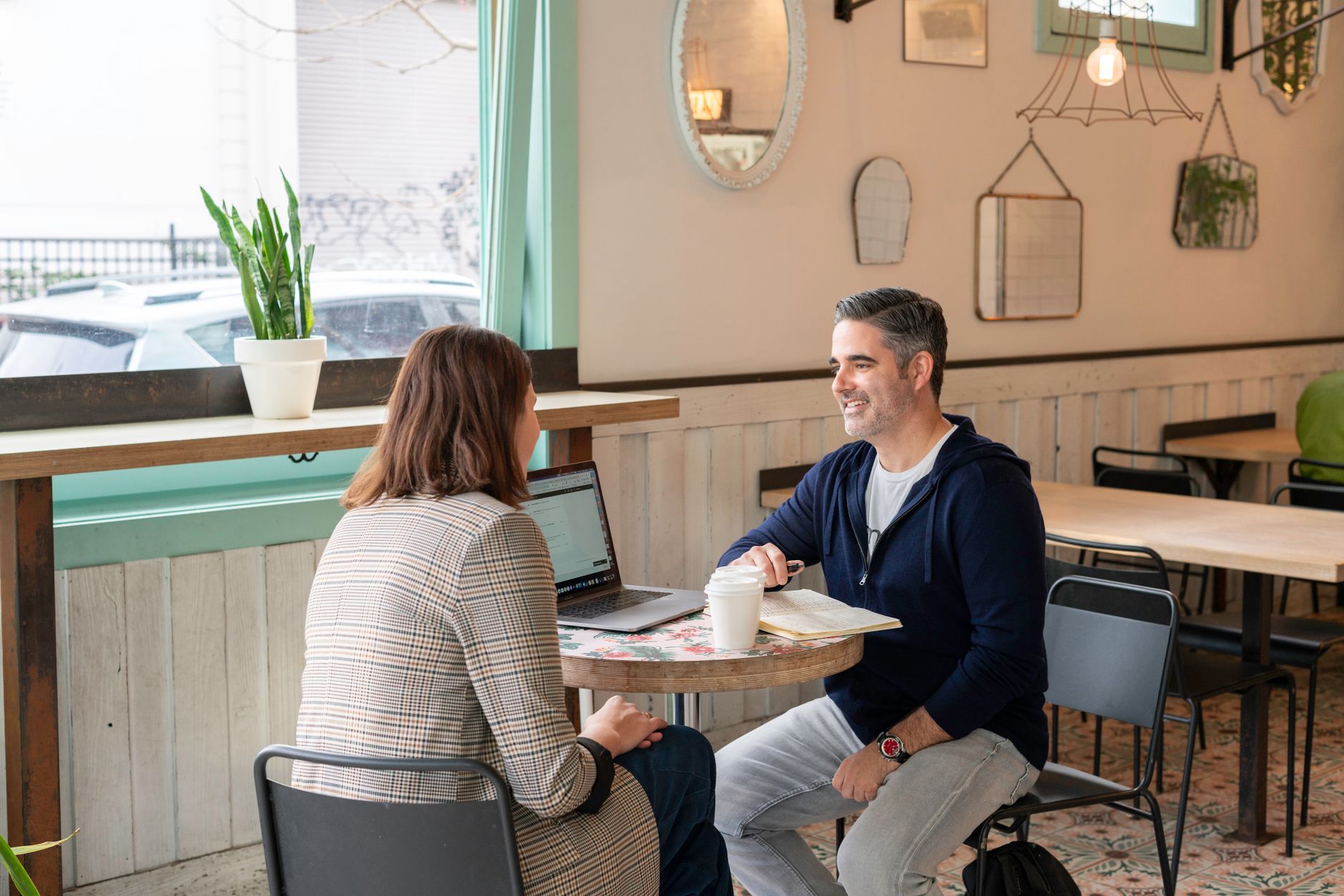 A business owner and a designer going through a website plan together